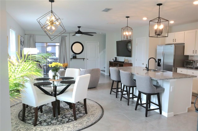 tiled dining space featuring sink and ceiling fan