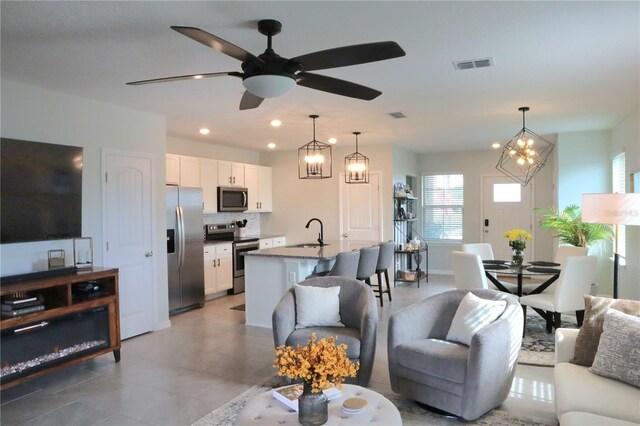 living room with sink and ceiling fan