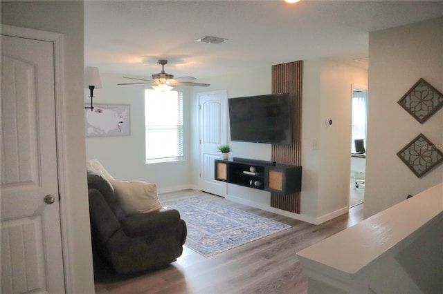 living room featuring light hardwood / wood-style floors and ceiling fan