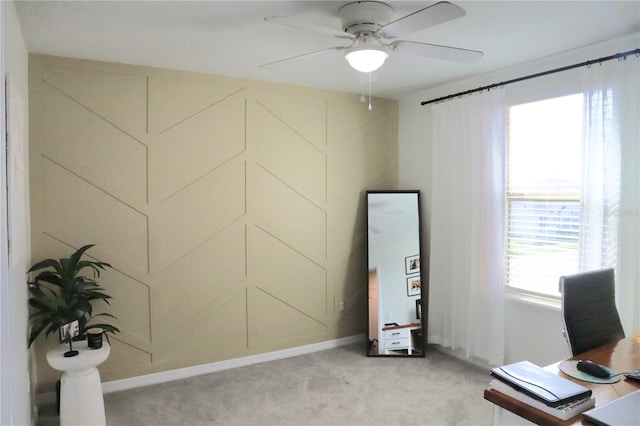 carpeted office space featuring ceiling fan