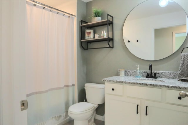 bathroom featuring vanity, toilet, and a shower with shower curtain