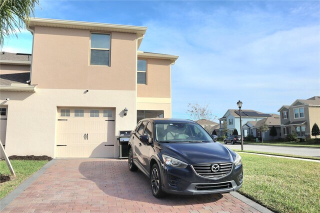 exterior space with a yard and a garage