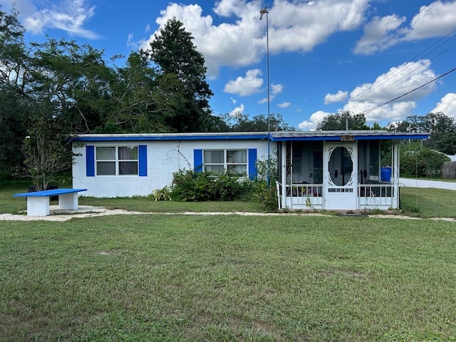 single story home featuring a front lawn and a sunroom