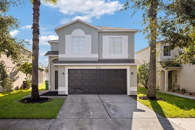 front of property featuring a garage and a front lawn