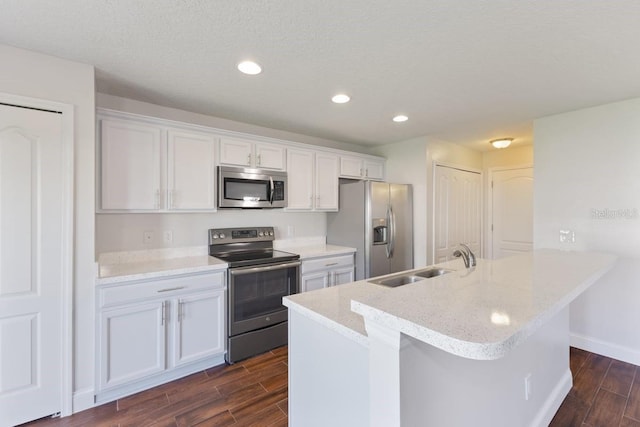 kitchen featuring white cabinets, stainless steel appliances, dark wood-type flooring, and sink