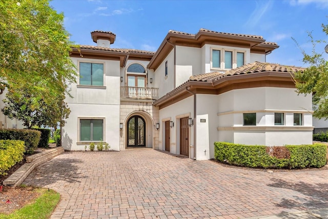 mediterranean / spanish-style home featuring a balcony