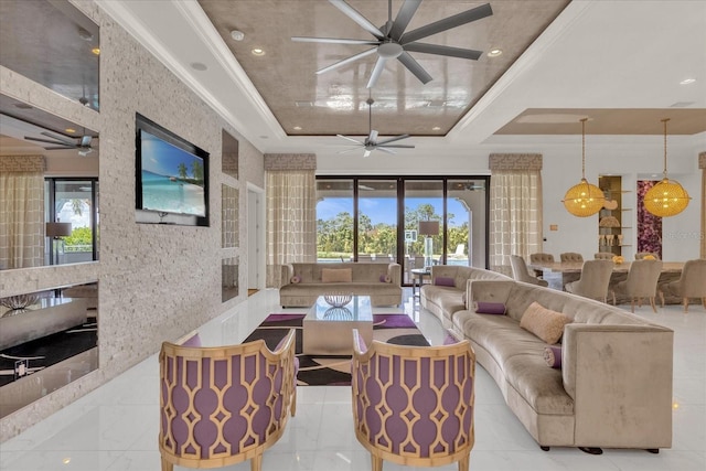 living room with a tray ceiling and ceiling fan