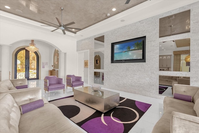 living room featuring ornamental molding, ceiling fan, and light tile patterned floors