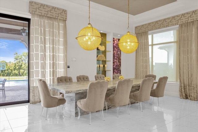 dining area featuring crown molding and ceiling fan with notable chandelier