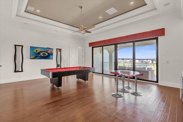 playroom featuring wood-type flooring, a tray ceiling, ceiling fan, and billiards