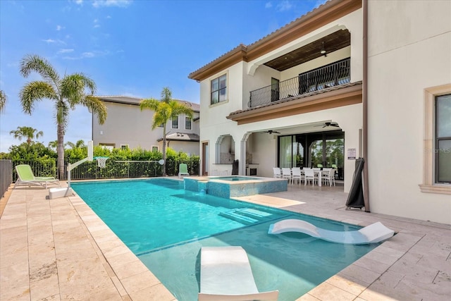 view of swimming pool featuring a patio, ceiling fan, and an in ground hot tub