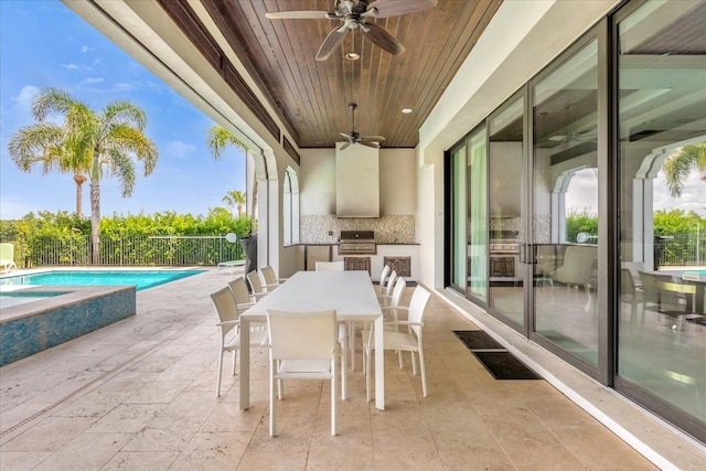 view of patio / terrace featuring exterior kitchen, a fenced in pool, ceiling fan, and a grill