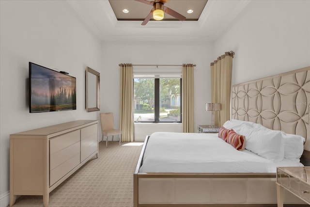 carpeted bedroom featuring a tray ceiling, a towering ceiling, and ceiling fan