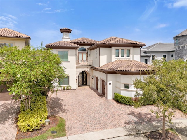 mediterranean / spanish-style home featuring a balcony