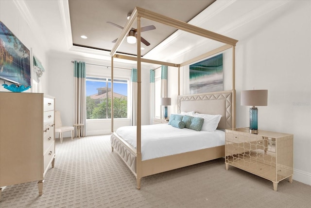 bedroom featuring a tray ceiling, ceiling fan, light colored carpet, and crown molding