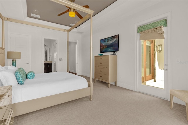 carpeted bedroom featuring ceiling fan, a tray ceiling, and connected bathroom