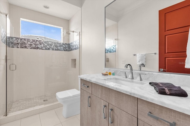 bathroom featuring tile patterned flooring, an enclosed shower, vanity, and toilet