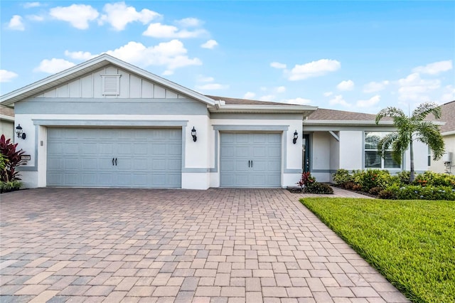 ranch-style home with a front yard and a garage