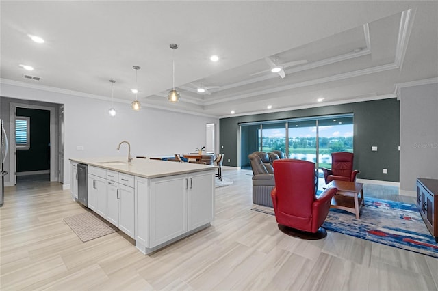 kitchen with an island with sink, white cabinetry, decorative light fixtures, and crown molding