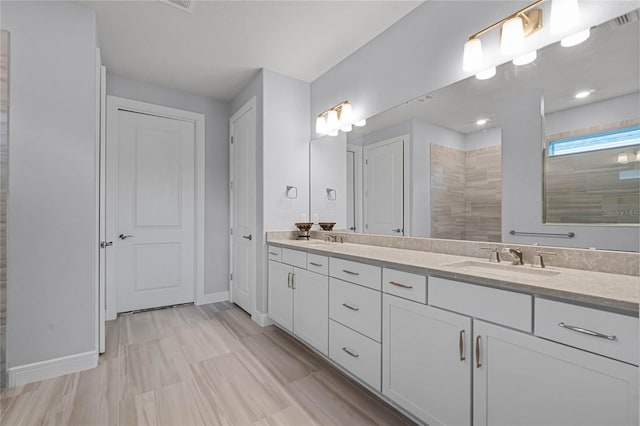 bathroom featuring vanity and a shower