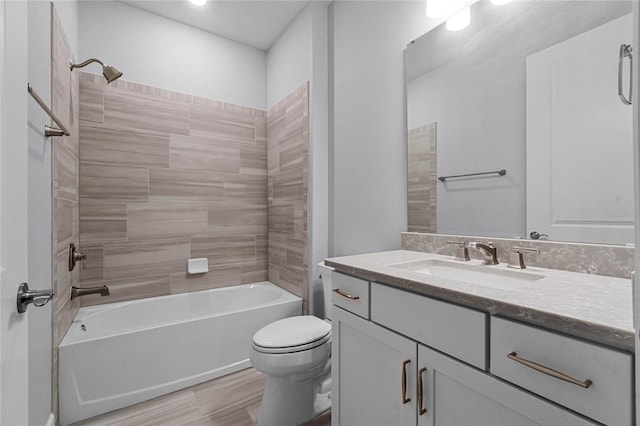 full bathroom with tiled shower / bath combo, vanity, and toilet