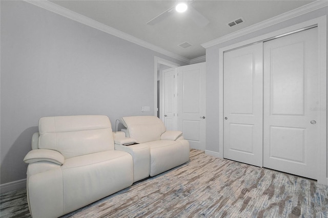 living area with crown molding and hardwood / wood-style floors