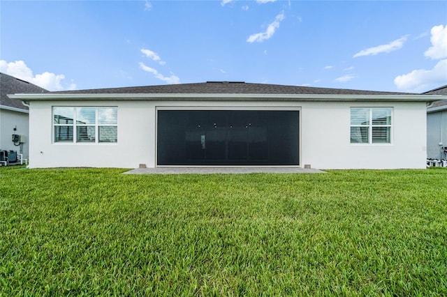 rear view of house with a yard