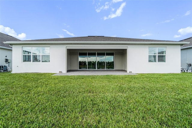 rear view of house with a lawn