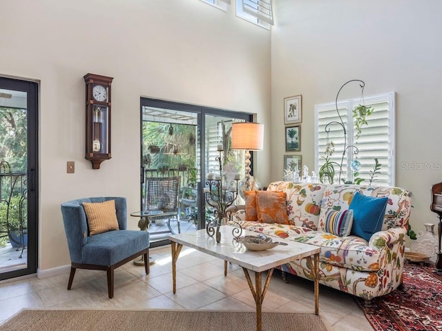 tiled living room featuring plenty of natural light and a high ceiling