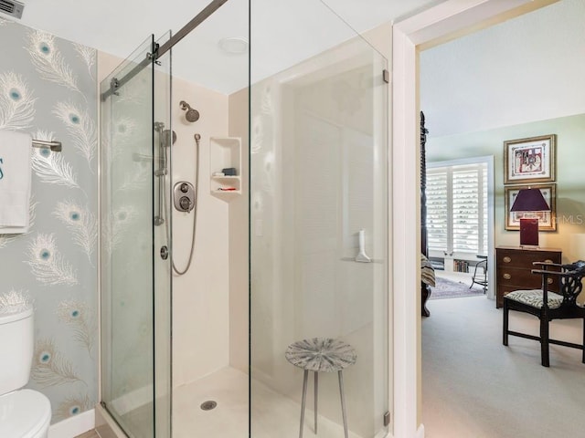 bathroom with toilet and an enclosed shower