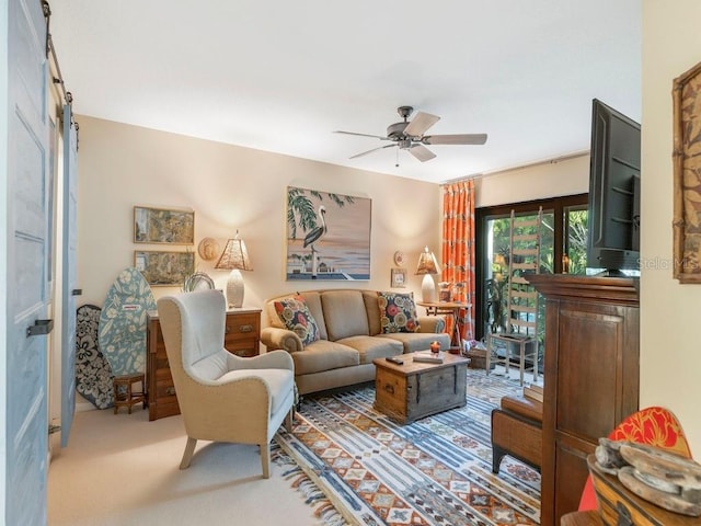 carpeted living room with ceiling fan