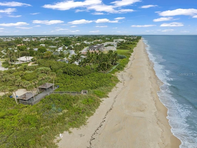 birds eye view of property with a beach view and a water view