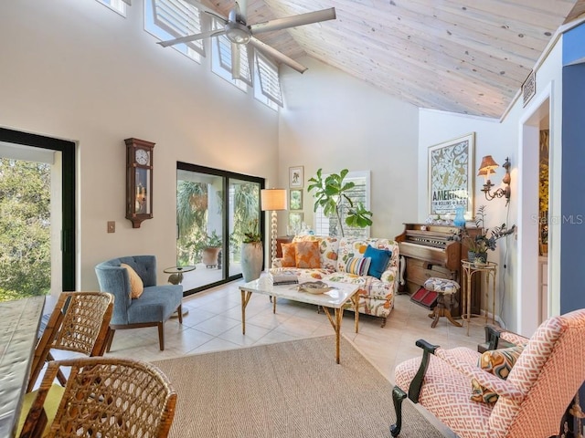 tiled living area with wood ceiling, plenty of natural light, high vaulted ceiling, and a ceiling fan