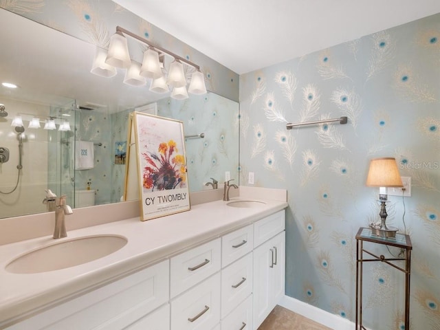 full bath featuring double vanity, a stall shower, wallpapered walls, and a sink