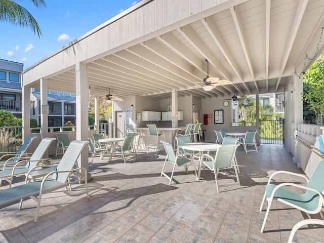 view of patio with outdoor dining area and a ceiling fan