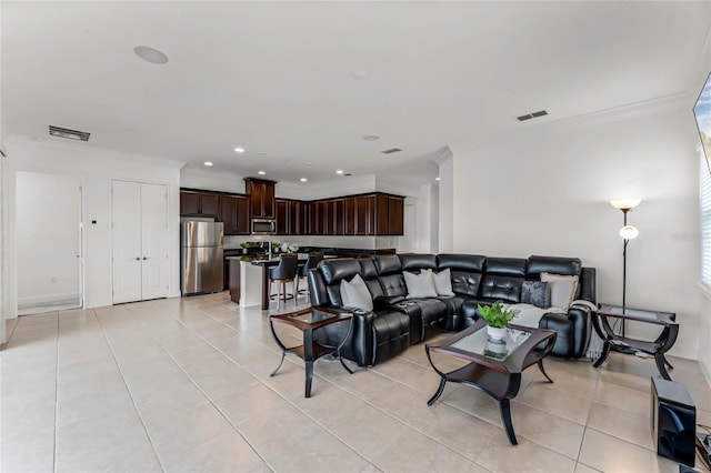 tiled living room featuring crown molding