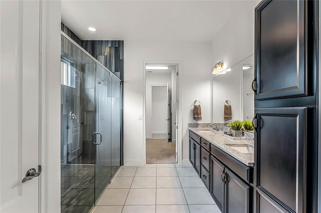 bathroom with tile patterned flooring, vanity, and a shower with shower door