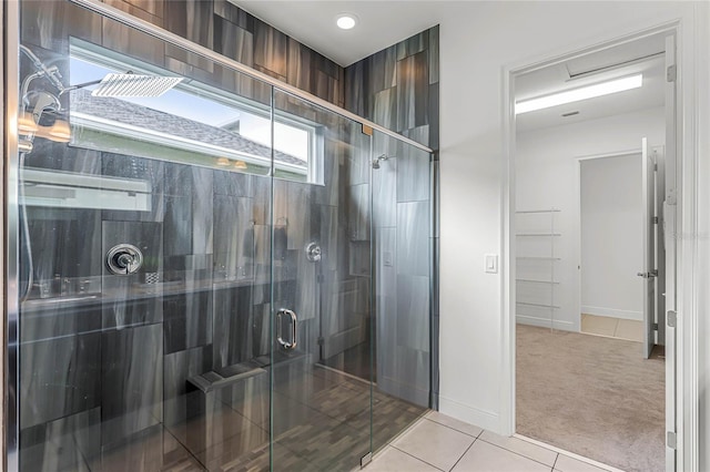 bathroom with walk in shower and tile patterned floors