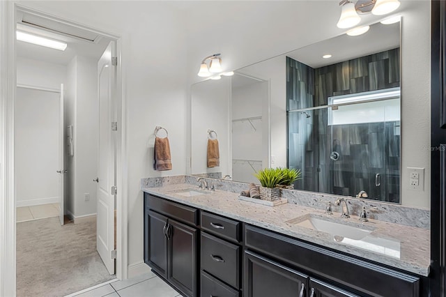 bathroom with vanity, tile patterned flooring, and an enclosed shower