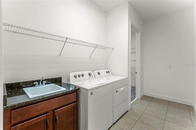 laundry area with washing machine and dryer, sink, and light tile patterned floors