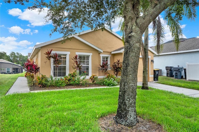 view of front of property with a front yard and a garage