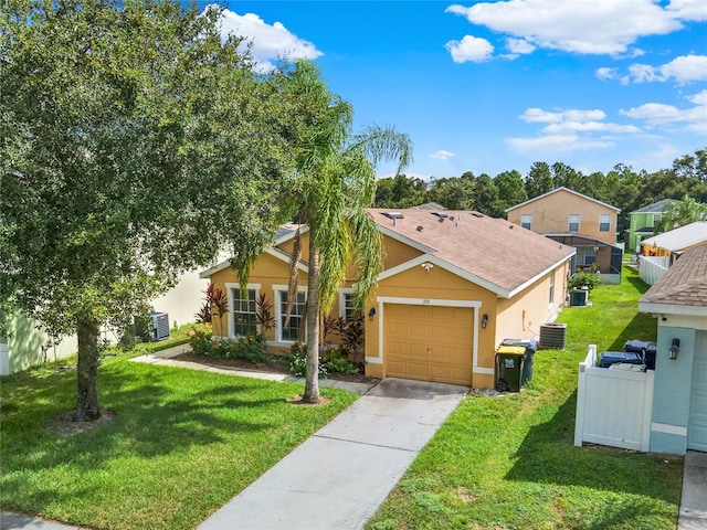 view of front of house featuring central AC, a front yard, and a garage