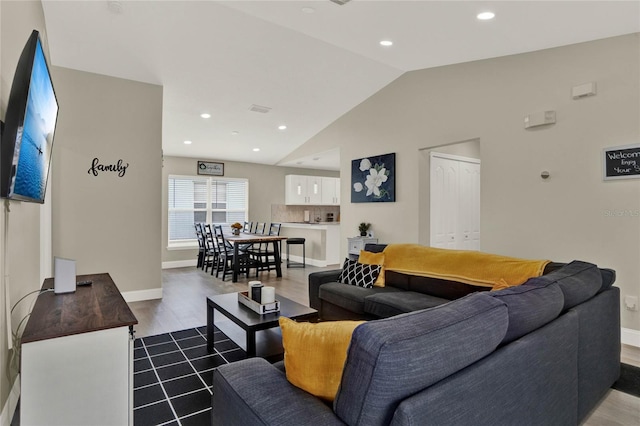 living room with light hardwood / wood-style flooring and vaulted ceiling