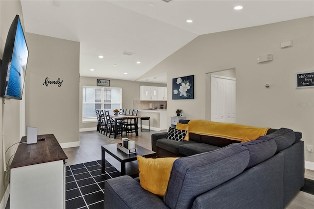 188 Ridgemont Ct, Davenport, FL 33896 - living area featuring dark wood finished floors, lofted ceiling, and recessed lighting