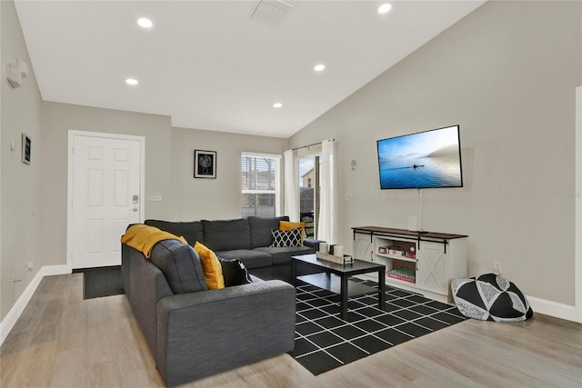 living room with hardwood / wood-style flooring and lofted ceiling