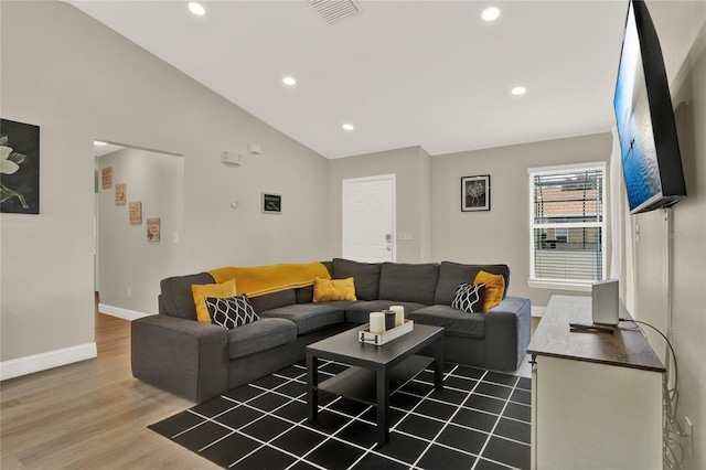 living room featuring high vaulted ceiling and hardwood / wood-style floors