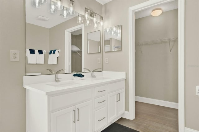 188 Ridgemont Ct, Davenport, FL 33896 - full bath with double vanity, wood finished floors, and a spacious closet