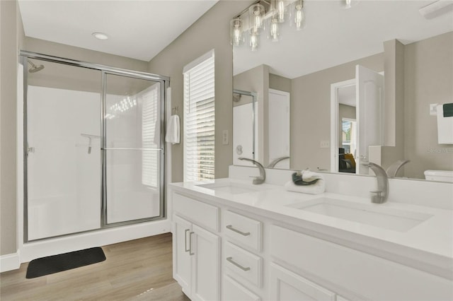188 Ridgemont Ct, Davenport, FL 33896 - ensuite bathroom featuring a shower stall, double vanity, and wood finished floors