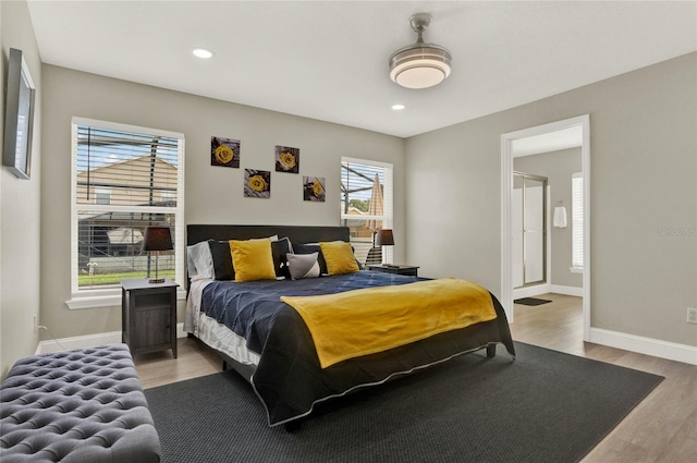 bedroom with wood-type flooring and ensuite bathroom