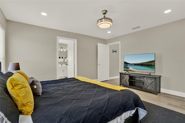 188 Ridgemont Ct, Davenport, FL 33896 - bedroom featuring wood finished floors, recessed lighting, and ensuite bath